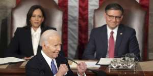 President Joe Biden gestures to Republicans as Vice President Kamala Harris and House Speaker Mike Johnson watch during the State of the Union address.