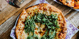 Pepperoni pizza and quattro cheese pizza with rosemary honey and rocket. 