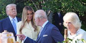 Donald and Melania Trump and King Charles and Queen Camilla look at a display on the South Lawn of the White House.