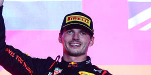 Max Verstappen celebrates on the podium after winning the F1 Grand Prix in Qatar.