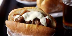 PIC SHOWS SAUSAGE AND BUN. PIC BY JENNIFER SOO,SMH. Shows sausages in bread rolls with onion confit and aioli.