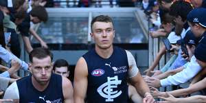 Sam Docherty and Patrick Cripps lead their team out on to the field during the round seven AFL match between the Bombers and the Blues.