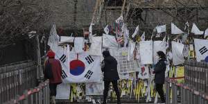 Visitors near the border between North and South Korea add to messages and flags of reunification hope. 