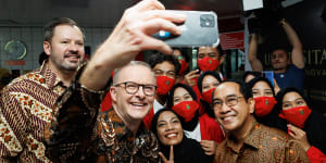 Industry and Science Minister Ed Husic and Prime Minister Anthony Albanese take a selfie with students at the Universitas Hasanuddin in Makassar,Indonesia.