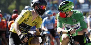 Britain's Adam Yates wearing the overall leader's yellow jersey speaks with Ireland's Sam Bennett,wearing the best sprinter's green jersey at the start of the sixth stage of the Tour de France.