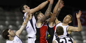 Jacob Weitering of the Blues and Tim Membrey fly for the ball.