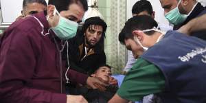 Medical staff treat a boy following a suspected chemical attack on his town of al-Khalidiya in Aleppo,Syria,in 2018.