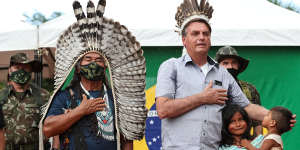 Brazilian President Jair Bolsonaro,centre,sings the Brazilian national anthem during a visit to an army border post on Yanomami reservation in Sao Gabriel da Cachoeira. 