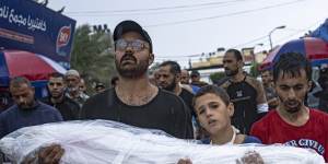 Palestinians mourn their relatives killed in the Israeli bombardment of the Gaza Strip,outside the hospital in Khan Younis
