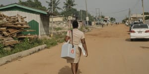 Nurse Deborah Sebi carries immunisations in a refrigerated box on her way to set up a mobile clinic in Teshie,a fishing village near Accra,Ghana.
