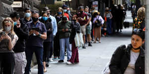 People queue outside Melbourne Town Hall Covid-19 testing centre on Wednesday.