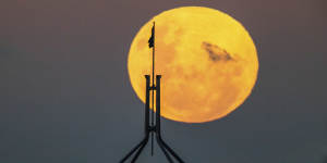 A supermoon is seen rising over Canberra with Parliament House in the foreground,on Wednesday 26 May 2021. fedpol Photo:Alex Ellinghausen