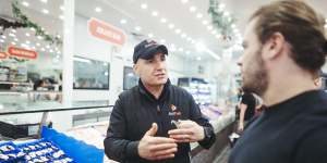 GetFish manager Carmelo Lombardo speaks with a customer as people flock to the Sydney Fish Market ahead of Christmas.