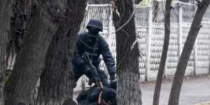 An armed riot police officer detains a protester in Almaty,Kazakhstan,on Saturday.
