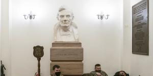 Members of the National Guard rest under a bust of Abraham Lincoln in a hallway of the US Capitol building in Washington ahead of Donald Trump's second impeachment vote.