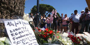 Floral tributes are laid out near the site of the truck attack in the French resort city of Nice on Friday.