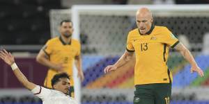 Abdullah Ramadan of United Arab Emirates and Australia’s Aaron Mooy fight for the ball.