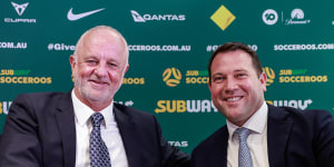 Graham Arnold shakes hands with Football Australia boss James Johnson after signing on as Socceroos coach for four more years.