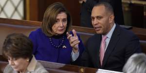 Representative Hakeem Jeffries talks with Representative Nancy Pelosi during the eighth vote in the House chamber.