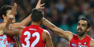 Over she goes:Adam Goodes of the Swans celebrates kicking a goal.