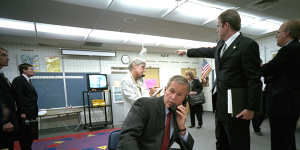 President George W. Bush gathers information about the terrorist attack from a classroom at Emma E. Booker Elementary School in Sarasota,Florida. Pictured second from left is CIA analyst Michael Morell with other White House staff.