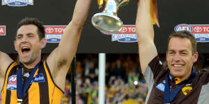 Once were warriors:Luke Hodge and Alastair Clarkson lift the 2014 premiership cup.