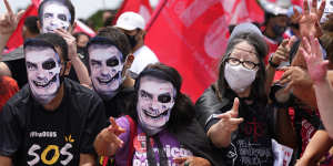 Demonstrators wear masks representing Brazilian President Jair Bolsonaro as they protest his government’s handling of the COVID-19 pandemic outside Planalto presidential palace in Brasilia,Brazil.