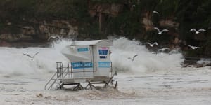 Waves wash over roads,lap at houses as wild weather hits NSW coast