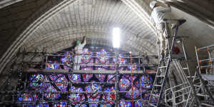Restorers work on stones around Notre-Dame’s west rose window,which was originally completed in about 1225.