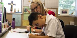 Elias Dahrie,6,reads using a whole-language method with teacher Maree Grainger.
