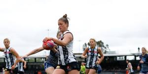 Collingwood’s Brianna Davey kicks her team forward against Geelong.