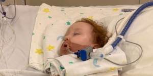 Gold Coast toddler Dustin Wildman remains in a critical condition after accidentally inhaling a decorative product used on cakes. 
