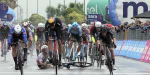 Mark Cavendish crashes in the final metres of stage 5 as Kaden Groves (left) nudges ahead for the win.