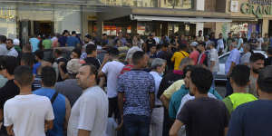 People wait in line for bread in front of a bakery in Beirut,in July. Lebanon has been without a president since October.