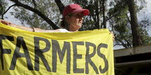NSW farmers Ted and Julia Borowski (holding banner) protest against Santos'coal seam gas project near the Pilliga State Forest.