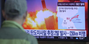 A man watches a TV screen in Seoul showing a file image of North Korea's missile launch.