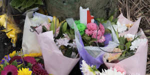 Mourners placed flowers and a broken P plate at the scene of the crash in McGraths Hill. 