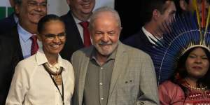 Re-elected Brazilian President Luiz Inacio Lula da Silva and his newly-named Environment Minister Marina Silva,left,smile during a meeting where he announced the ministers for his incoming government,in Brasilia,on the eve of his inauguration. On his right is Sonia Guajajara,minister for indigenous peoples.