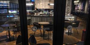 A server wears a mask in an empty restaurant after authorities asked restaurants in the area to only serve takeaway food in an effort to prevent the spread of COVID-19 in Chaoyang District,Beijing,on November 18.