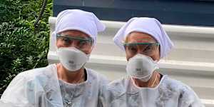 Twinnies Pelican and Seabird Rescue owners Bridgette and Paula Powers wearing PPE to handle a sick bird.