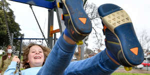 Toby Cummings’ son Louis. 8,enjoys his last swing at a public playground for at least two weeks on Monday.