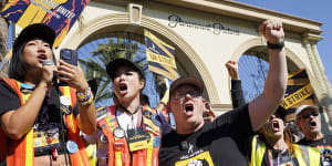 SAG-AFTRA captains Iris Liu and Miki Yamashita and chief negotiator Duncan Crabtree-Ireland lead a cheer for striking actors outside Paramount Pictures studio on Friday in Los Angeles. (AP Photo/Chris Pizzello)
