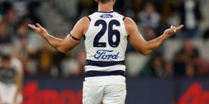 Tom Hawkins holds his arms out after giving away a 50-metre penalty.