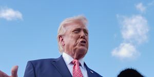 President Donald Trump speaks to reporters after stepping off Air Force One on Friday.
