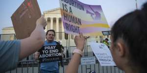 Demonstrators on both sides of the abortion issue outside the US Supreme Court after it struck down federal abortion rights protections.