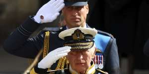 King Charles III and Prince William salute during the state funeral of Queen Elizabeth II.