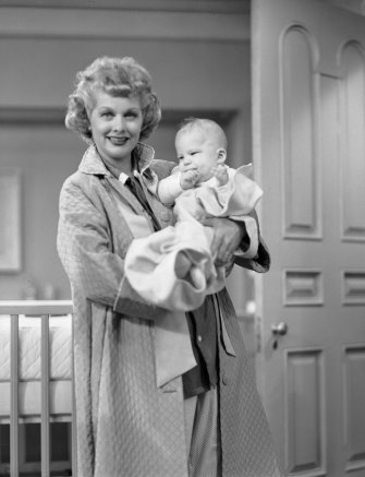 Lucille Ball as Lucy Ricardo, holding one twin, Richard Lee Simmons as Little Ricky Jr.