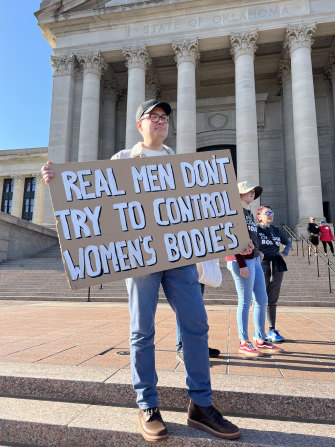 A man holds up a sign during a protest at the Oklahoma State Capitol.