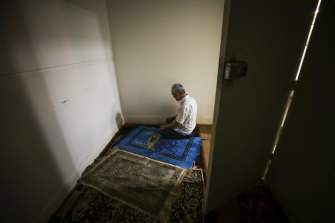 Abdulwali Muhammad during evening prayers in a prayer room while dining at a Uighur restaurant that used to be a church.