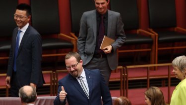 Senator Ricky Muir gives the thumbs up to Senate Leader Eric Abetz after he made his first speech to the Senate in Canberra on Thursday.